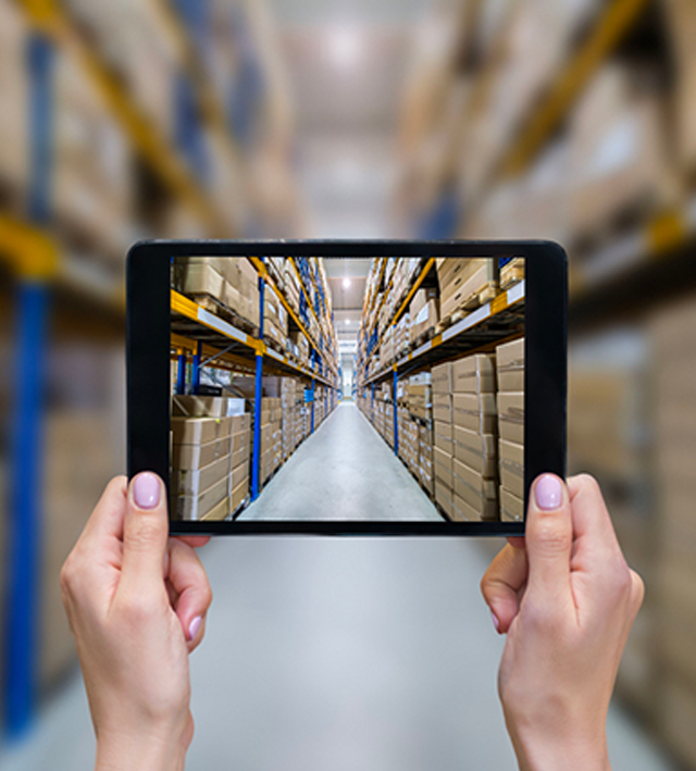 A warehouse manager who uses their tablet and cloud ERP software to carry out their work.