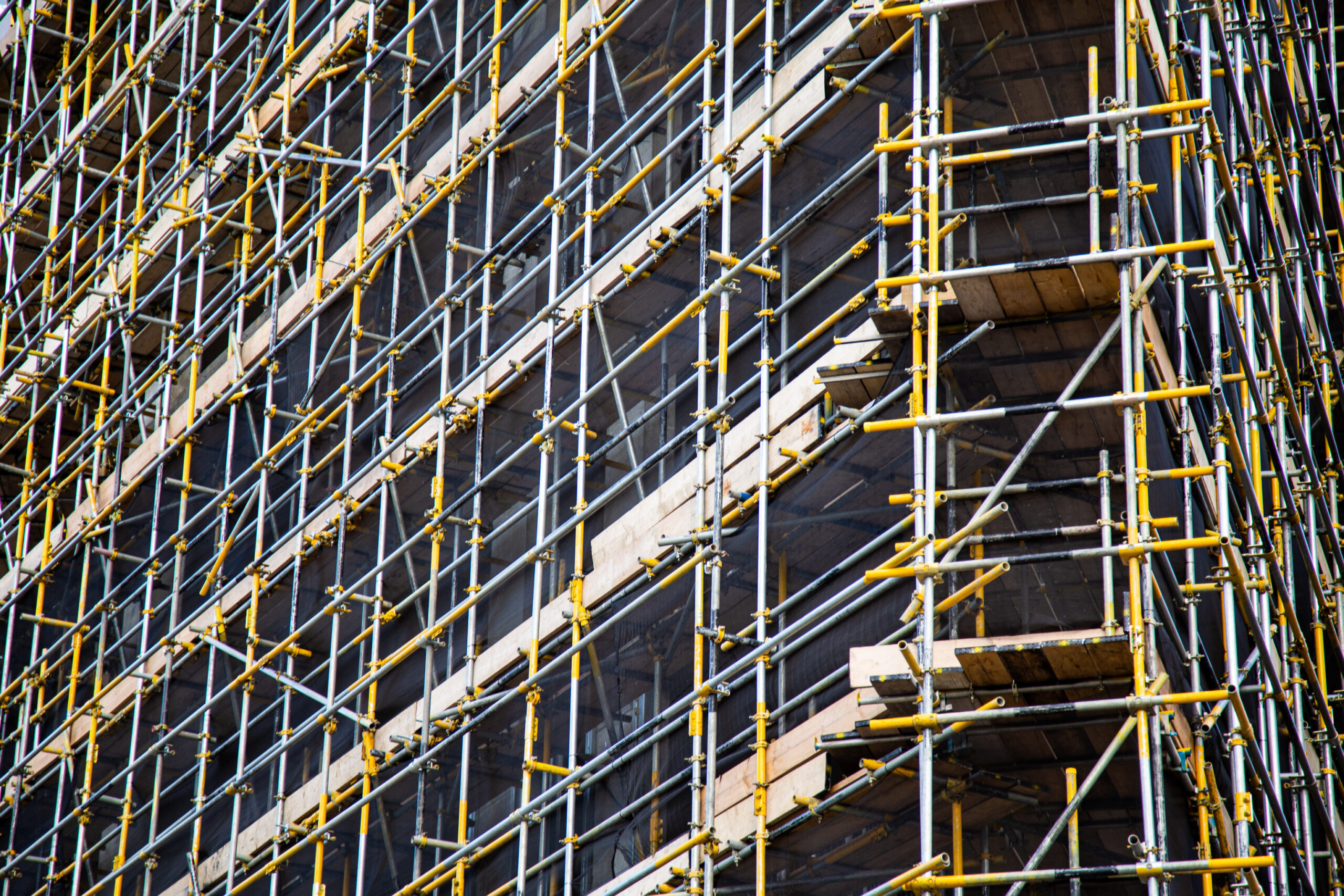 Scaffolding around the structure of a building under construction.