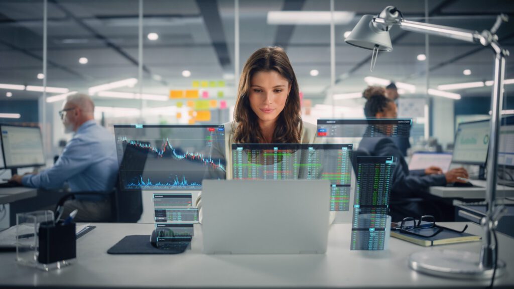 Person working with multiple computers screens