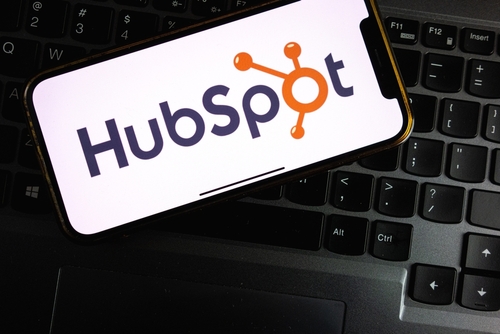 HubSpot logo displayed on a smartphone placed on a computer keyboard.