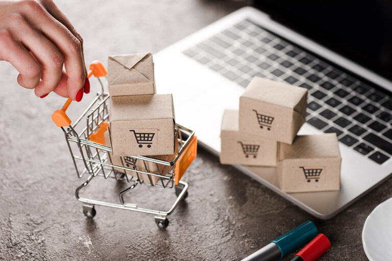 Online shopping concept featuring a laptop and packages.